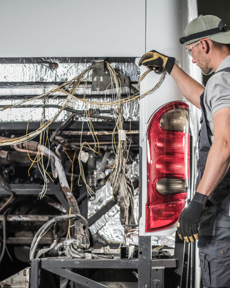 Caucasian Bus Service Technician in His 40s Staying in Front of Vehicle Without Diesel Engine Preparing Himself For Another Step.