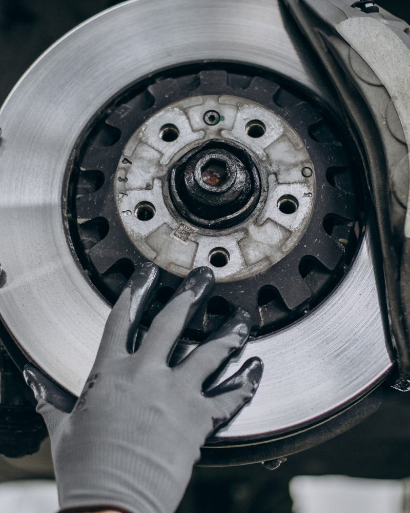 Mechanic changing brake discs in car service